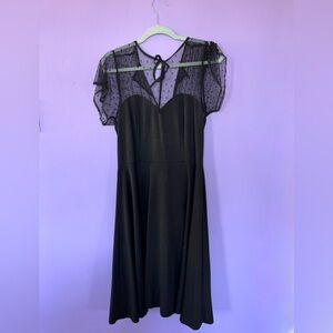 Elegant Black Dress with Sheer Polka Dot Sleeves
